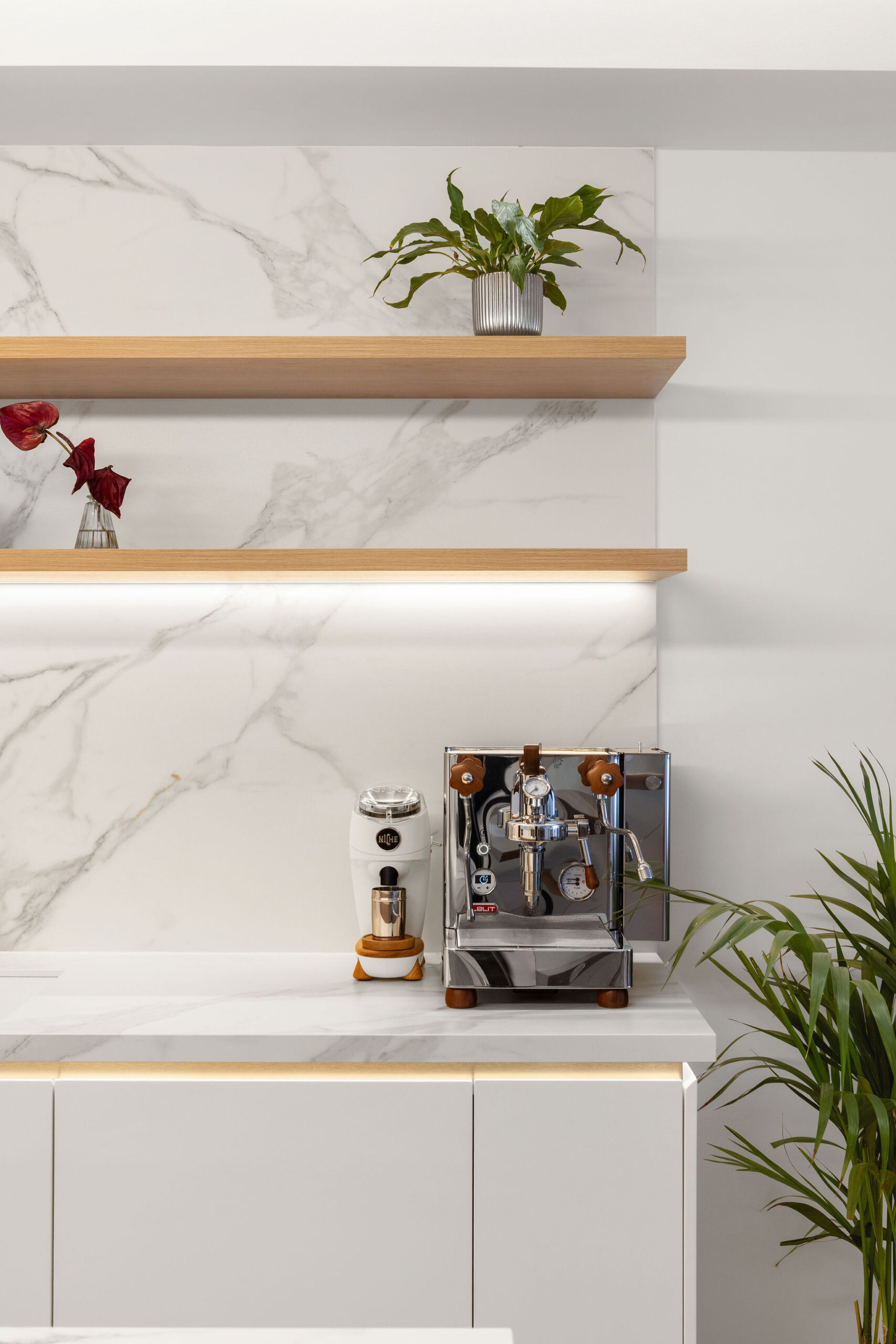 Kitchen overhead open shelving in woodgrain finish with LED lighting under