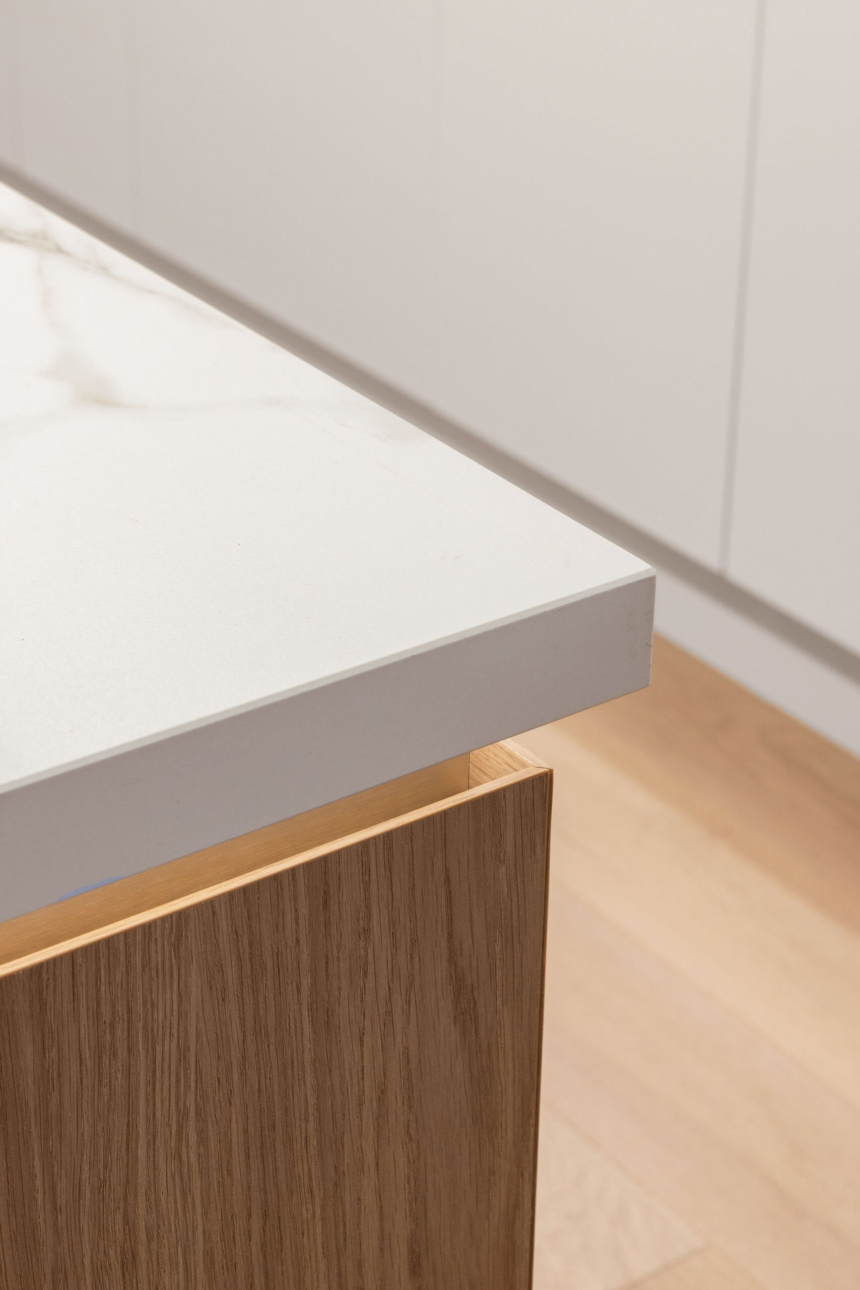 Custom kitchen design with brass shadowline detail and LED lighting in kitchen island bench