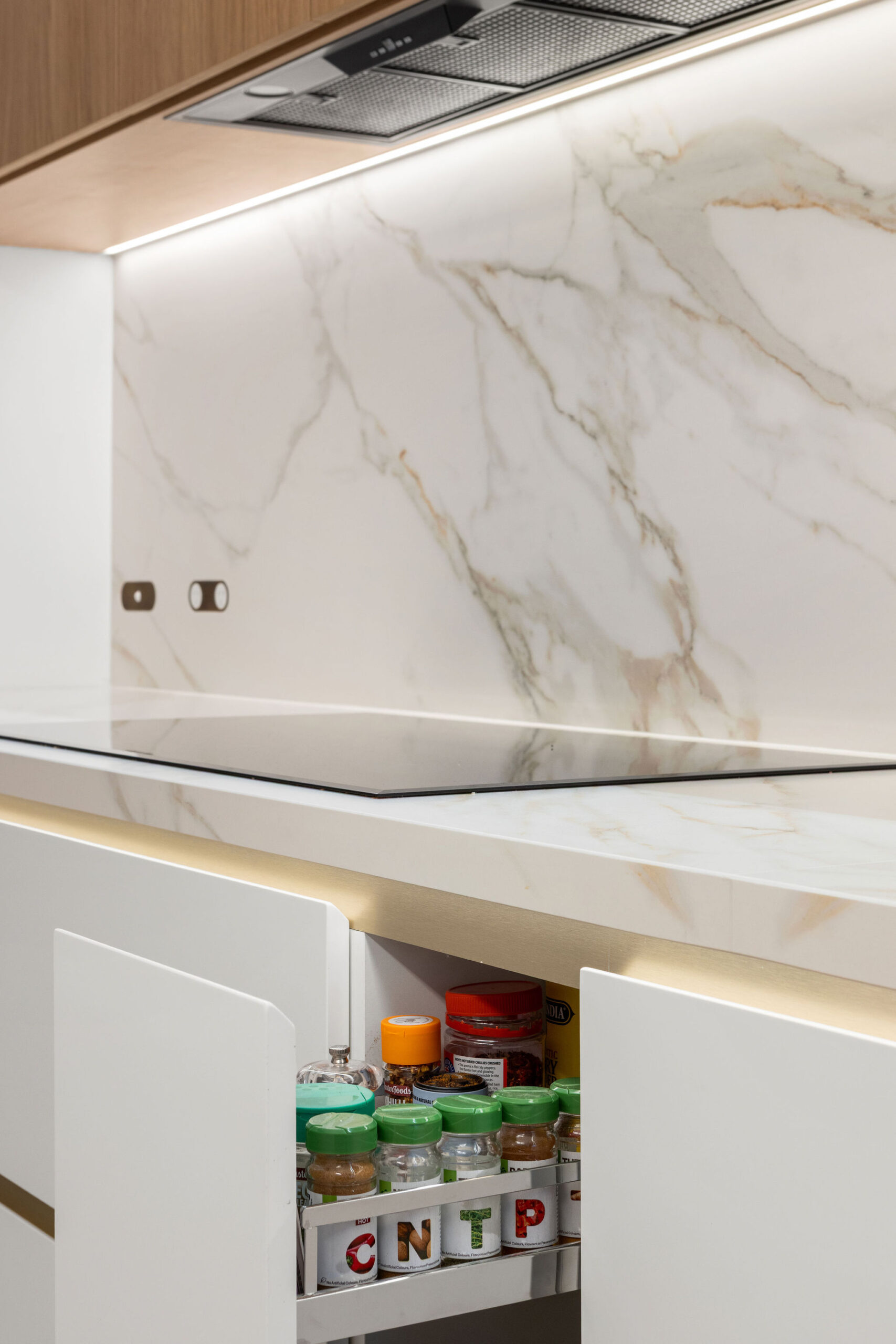 Kitchen cooking area with Hafele pull out spice cabinet